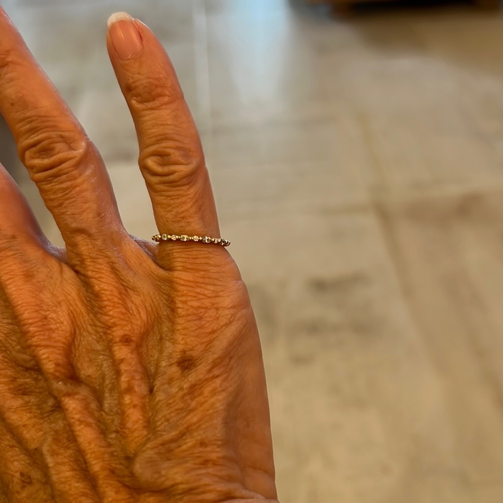 14k gold eternity band with moissanite stones completely around.